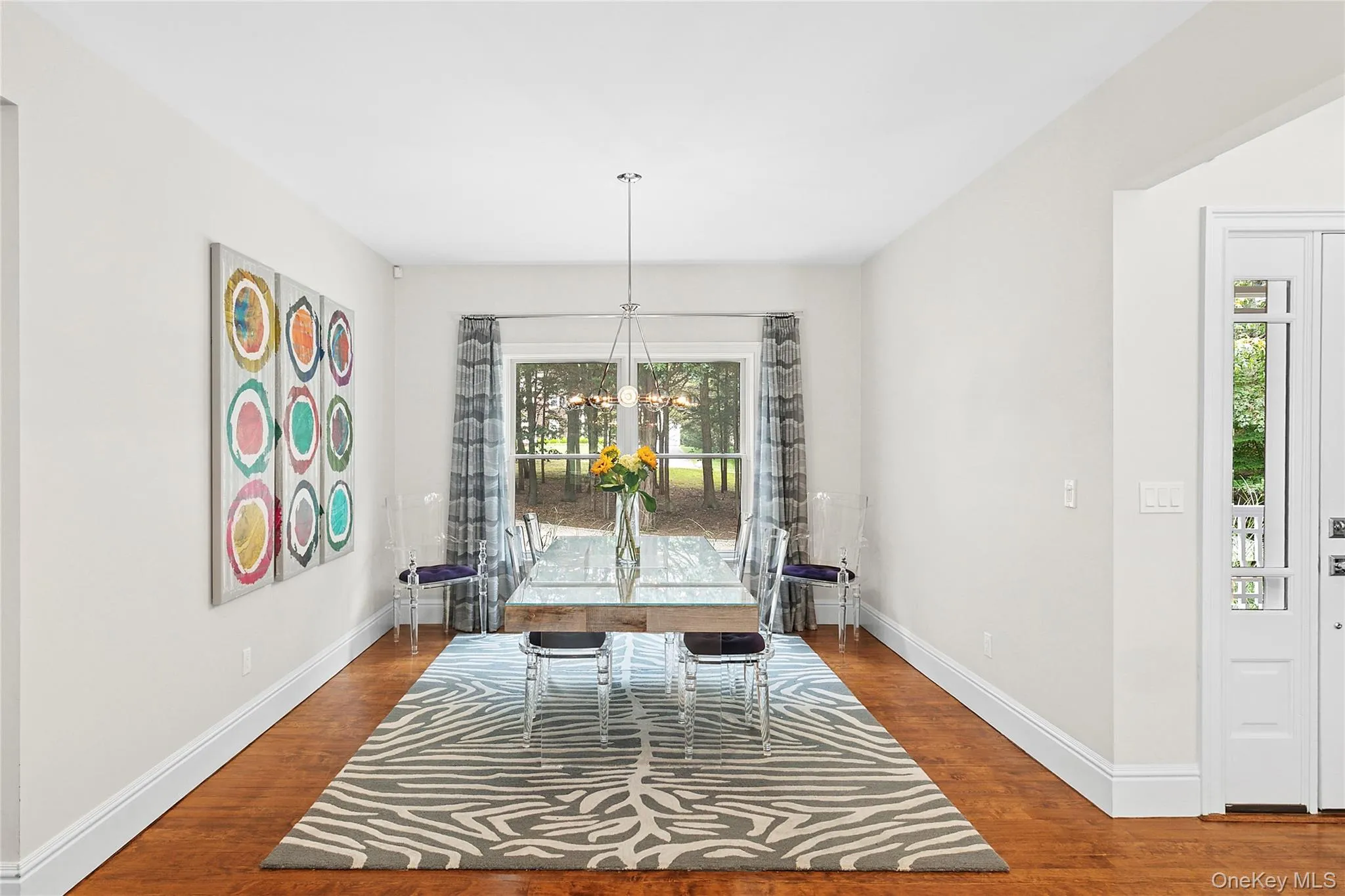 Dining space featuring wood floors and a chandelier Dining space featuring wood floors and a chandelier