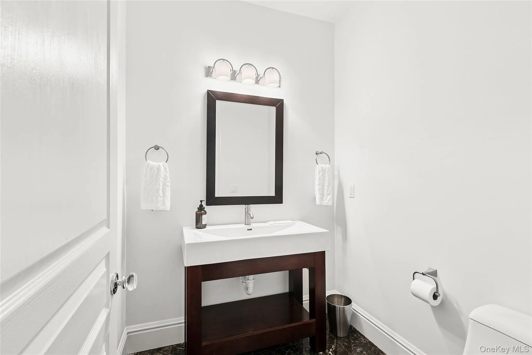 Half bath with vanity and baseboards Half bath with vanity and baseboards