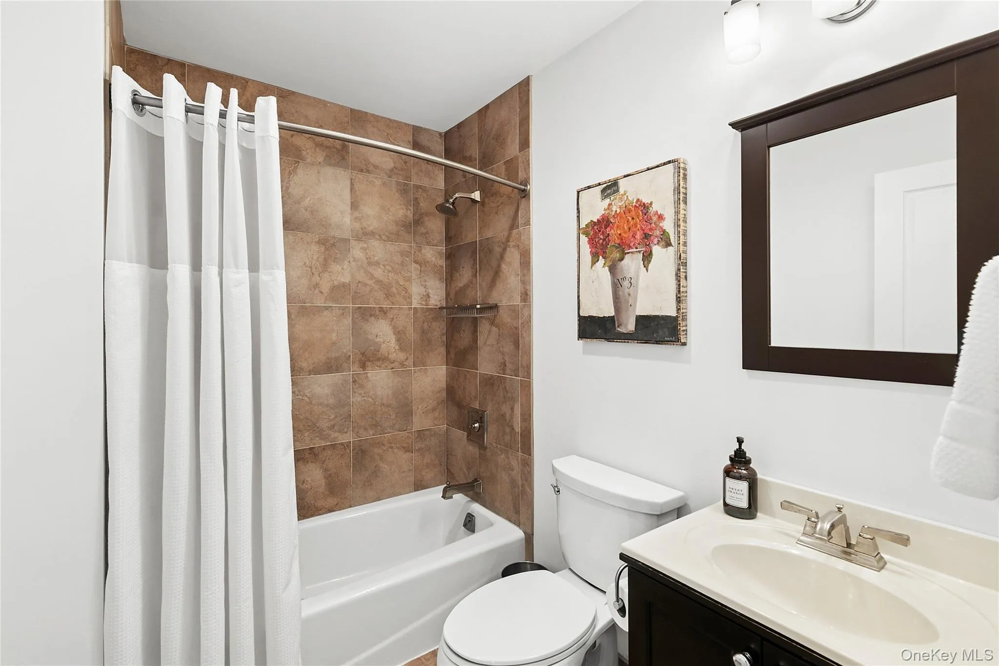 Bathroom featuring vanity and shower / bathtub combination Bathroom featuring vanity and shower / bathtub combination