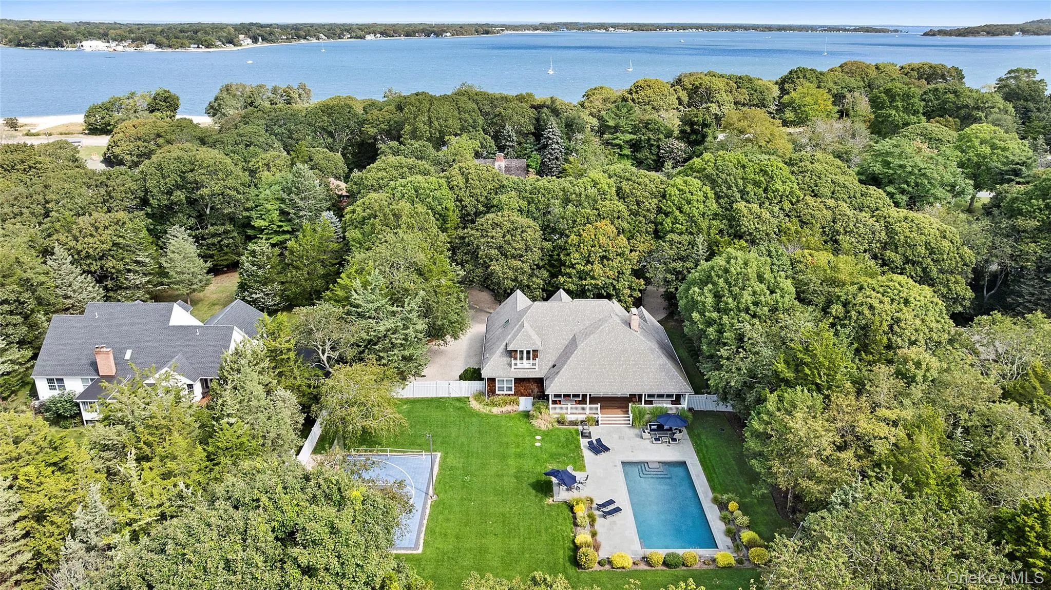 View of subject property featuring a pool and a large body of water View of subject property featuring a pool and a large body of water