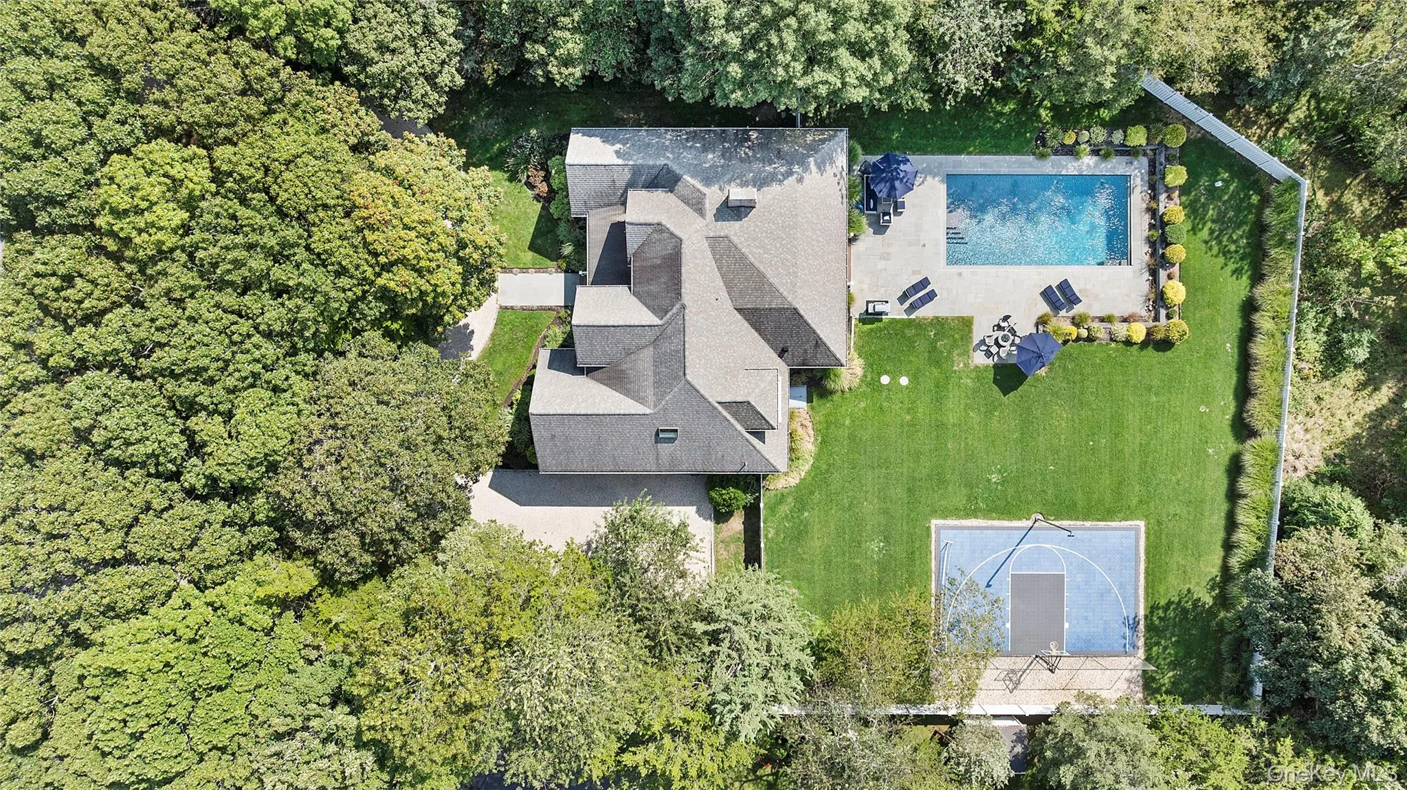 Aerial view of property and surrounding area featuring a pool Aerial view of property and surrounding area featuring a pool