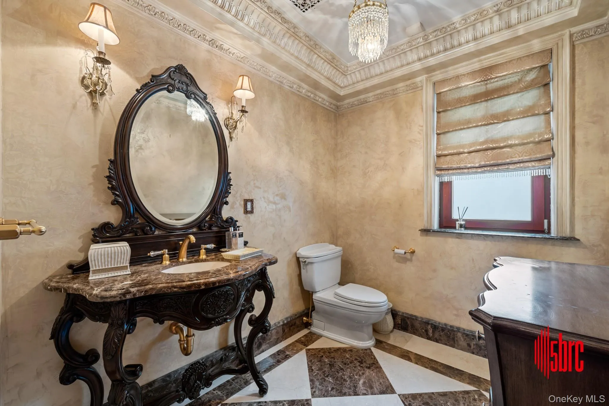 Half bathroom featuring inlaid floor details, a chandelier, and vanity Half bathroom featuring inlaid floor details, a chandelier, and vanity
