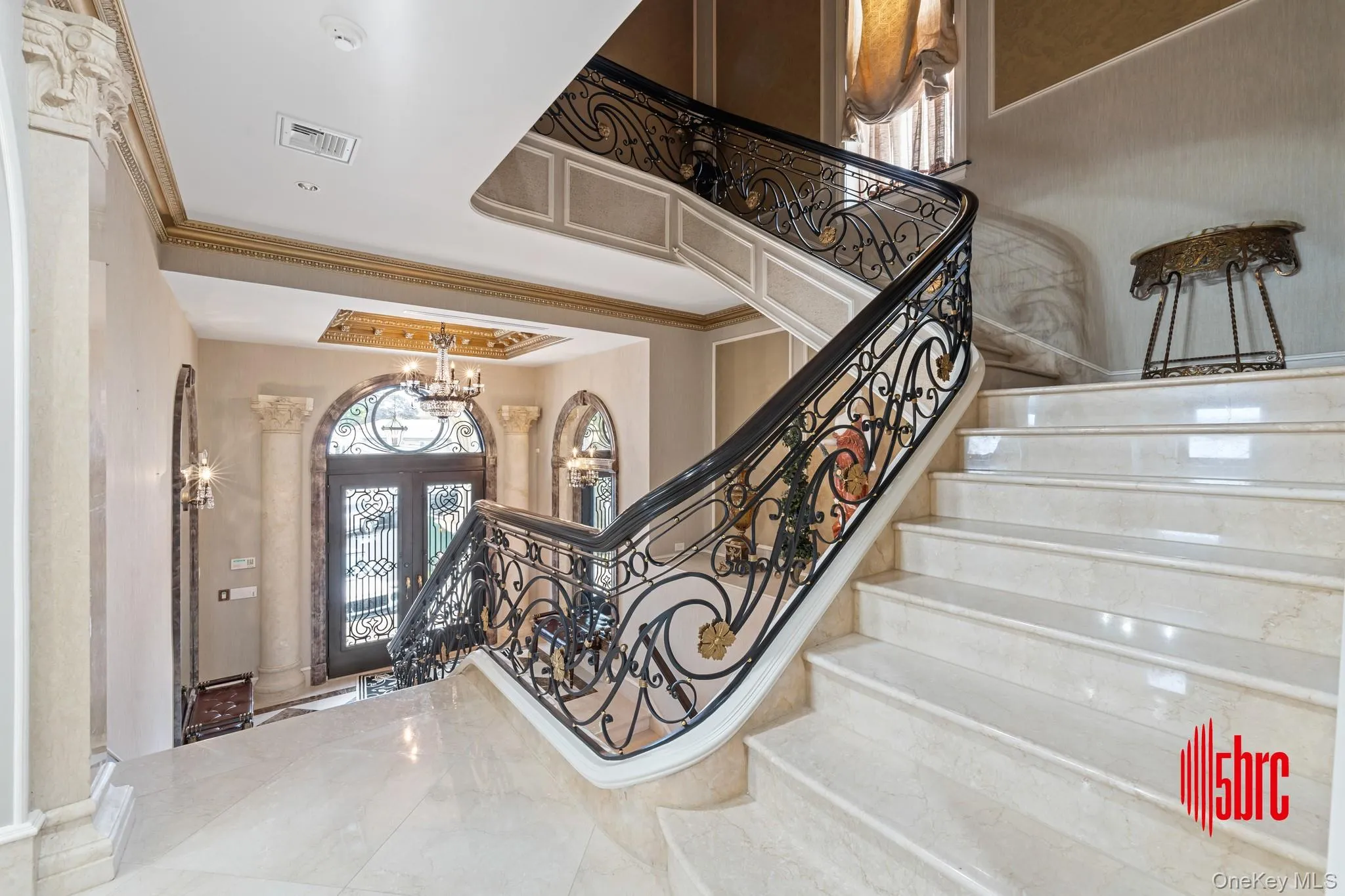 Foyer featuring ornamental molding, a chandelier, and stairway Foyer featuring ornamental molding, a chandelier, and stairway