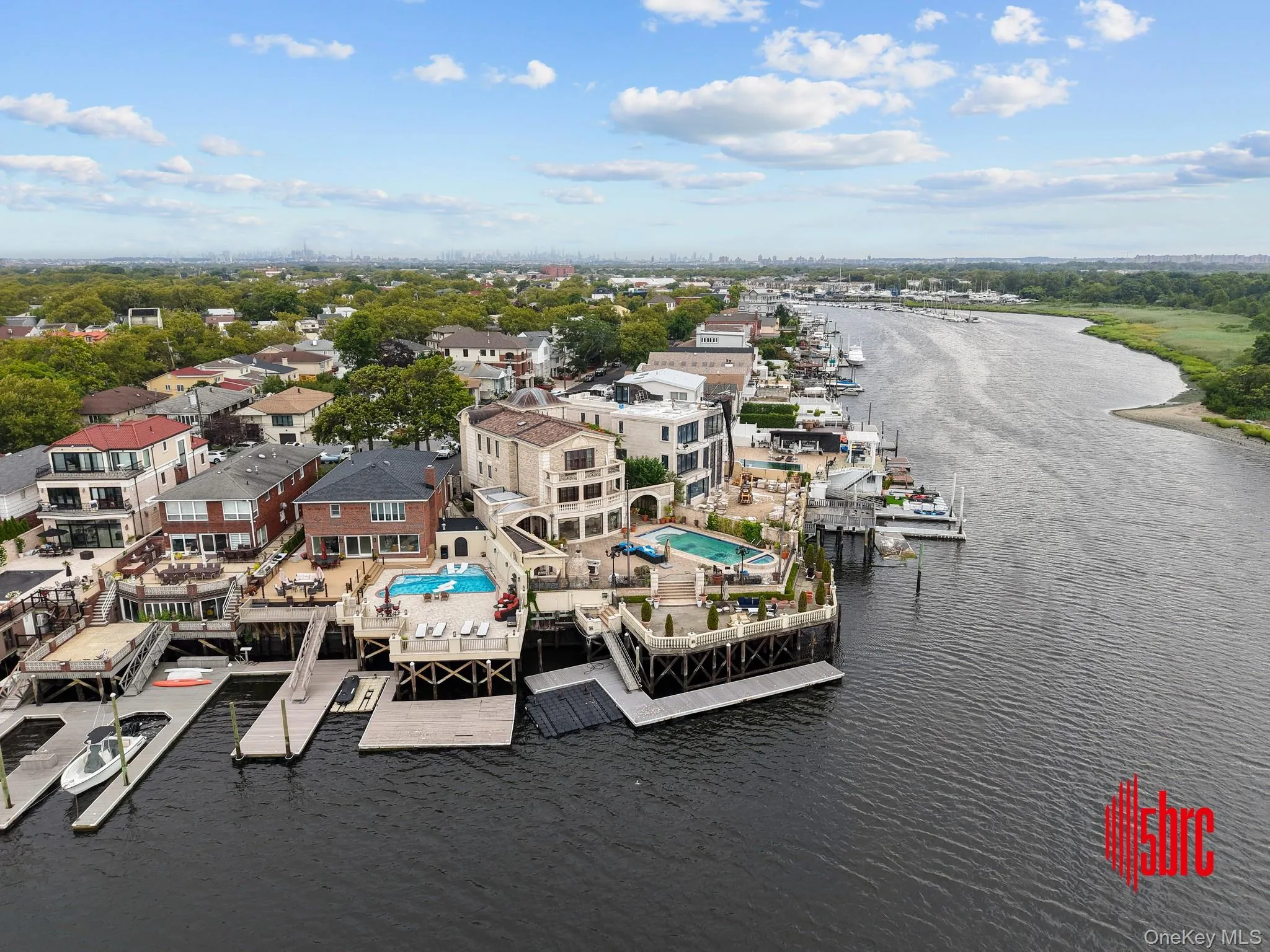 Drone / aerial view of a nearby body of water and a pool area Drone / aerial view of a nearby body of water and a pool area
