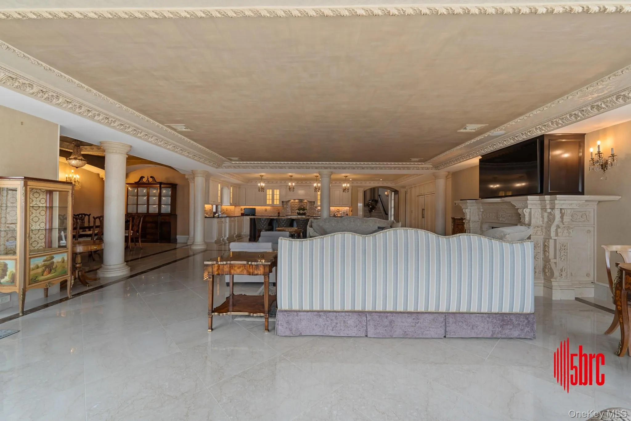 Living area with decorative columns, a tray ceiling, and ornamental molding Living area with decorative columns, a tray ceiling, and ornamental molding