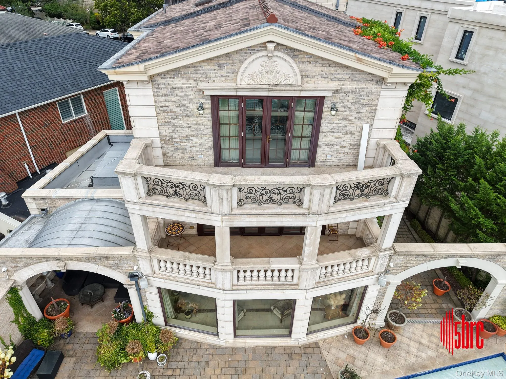 Back of house featuring a patio area and brick siding Back of house featuring a patio area and brick siding