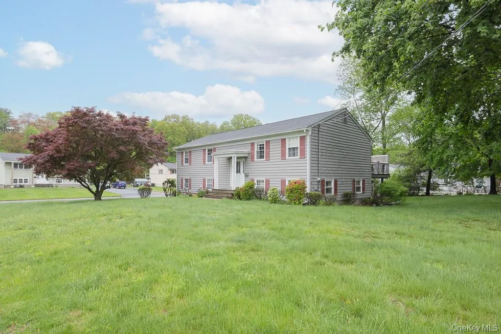 Split foyer home featuring a front yard Split foyer home featuring a front yard