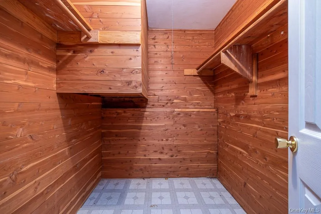 Walk in closet with light flooring Walk in closet with light flooring