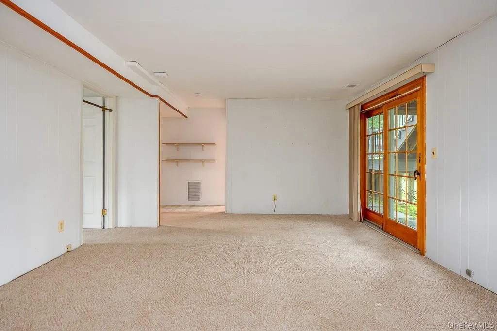 Unfurnished living room with carpet flooring Unfurnished living room with carpet flooring