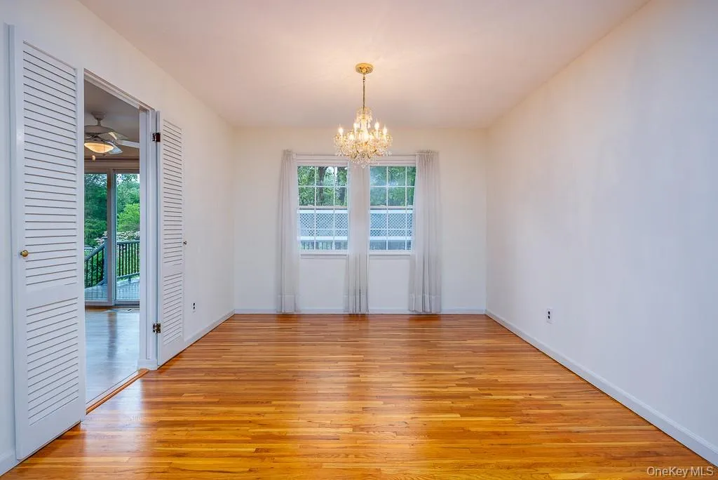 Unfurnished dining area featuring plenty of natural light, light wood finished floors, and a chandelier Unfurnished dining area featuring plenty of natural light, light wood finished floors, and a chandelier