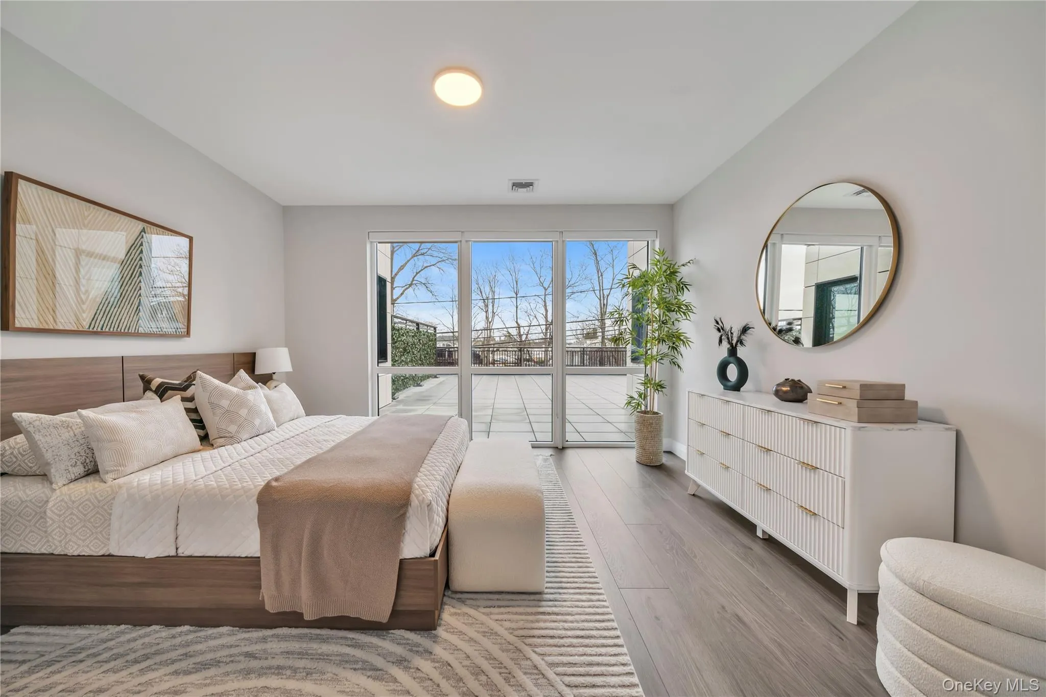 Bedroom featuring visible vents and wood finished floors Bedroom featuring visible vents and wood finished floors