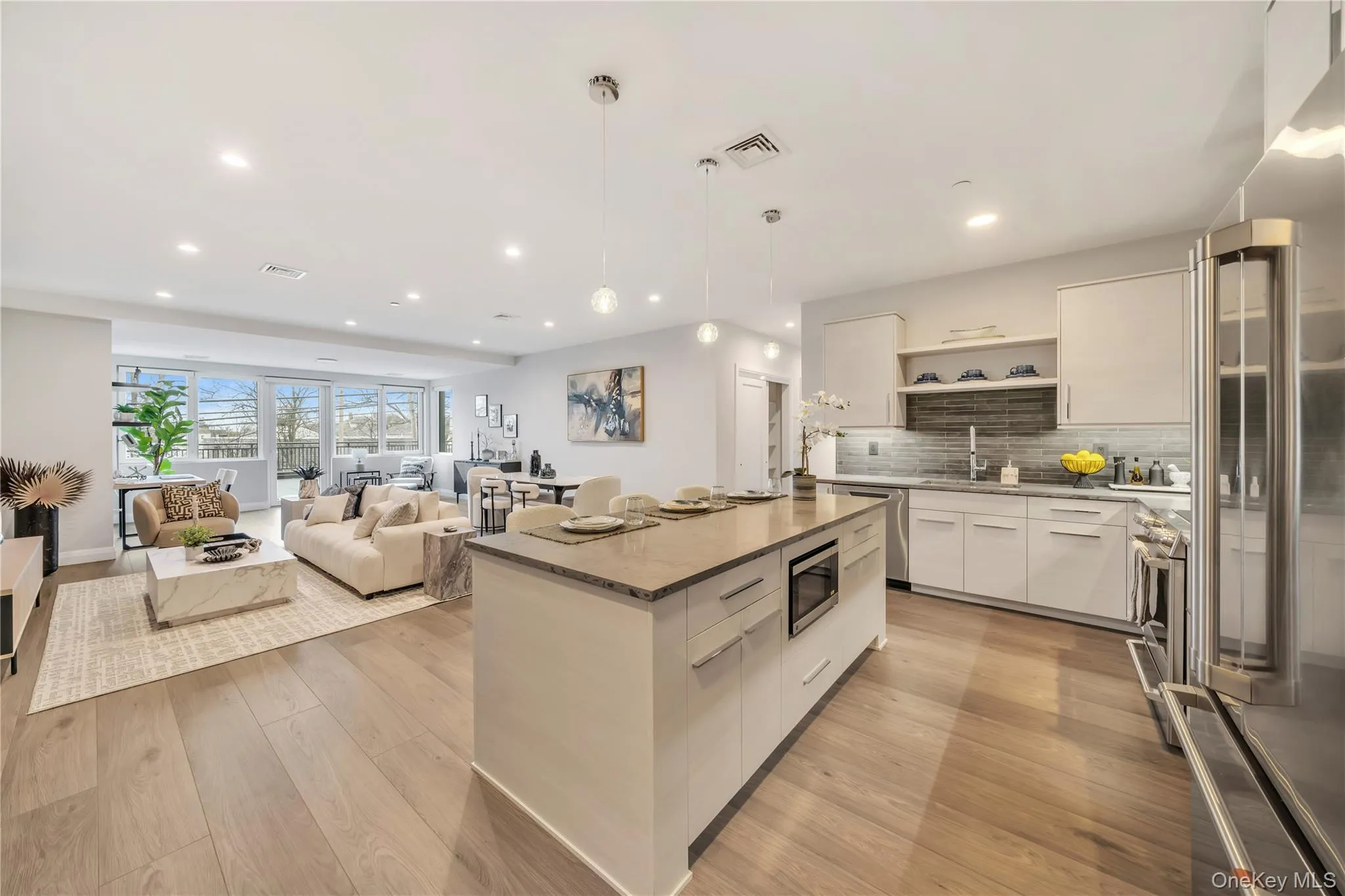 Kitchen with visible vents, appliances with stainless steel finishes, modern cabinets, open shelves, and a sink Kitchen with visible vents, appliances with stainless steel finishes, modern cabinets, open shelves, and a sink