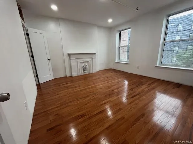 Unfurnished living room featuring hardwood / wood-style floors and recessed lighting Unfurnished living room featuring hardwood / wood-style floors and recessed lighting
