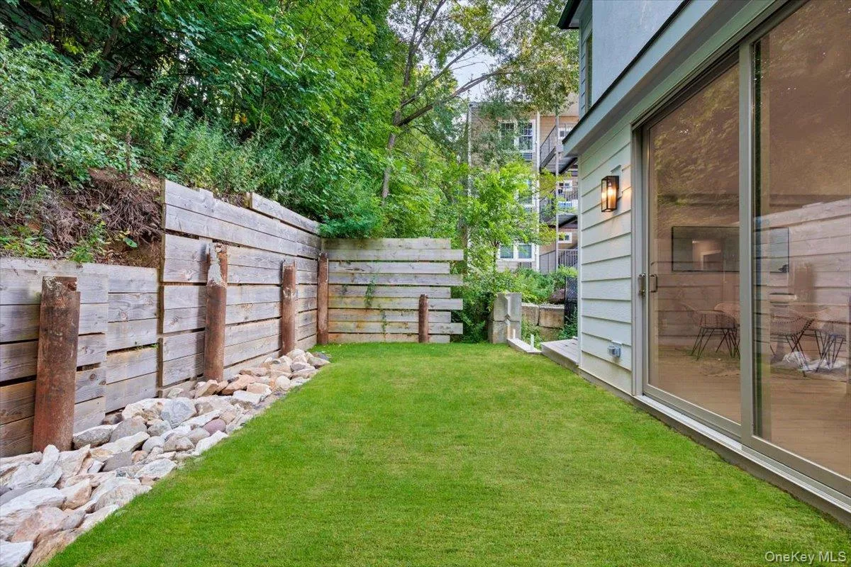 Landscaped private yard with fencing-ideal for outdoor relaxation. Landscaped private yard with fencing-ideal for outdoor relaxation.