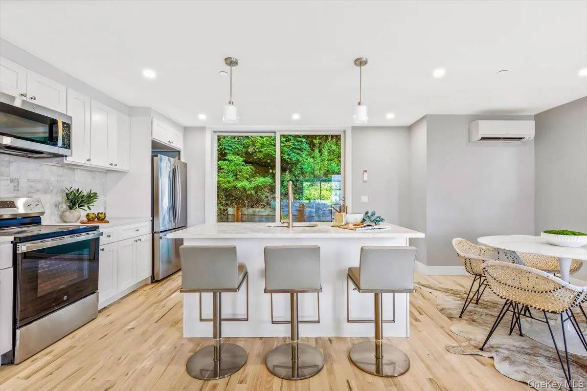A chef-inspired kitchen featuring quartz countertops, custom cabinetry, and seamless flow for entertaining. A chef-inspired kitchen featuring quartz countertops, custom cabinetry, and seamless flow for entertaining.