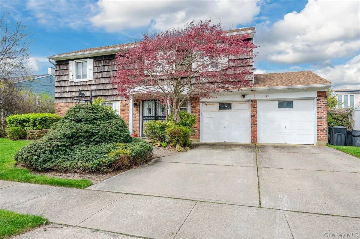 View of front of property featuring brick siding, concrete driveway, a garage, and a shingled roof View of front of property featuring brick siding, concrete driveway, a garage, and a shingled roof