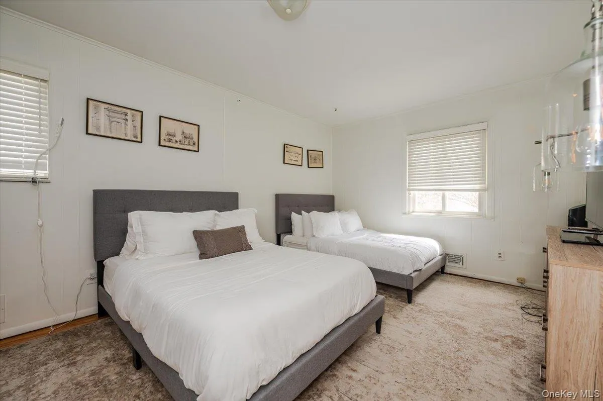 Bedroom featuring baseboards and ornamental molding Bedroom featuring baseboards and ornamental molding