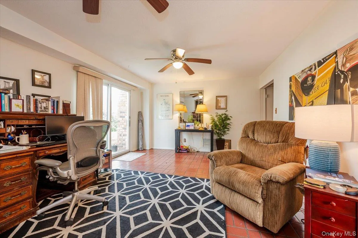 Office space featuring a ceiling fan and tile patterned floors Office space featuring a ceiling fan and tile patterned floors