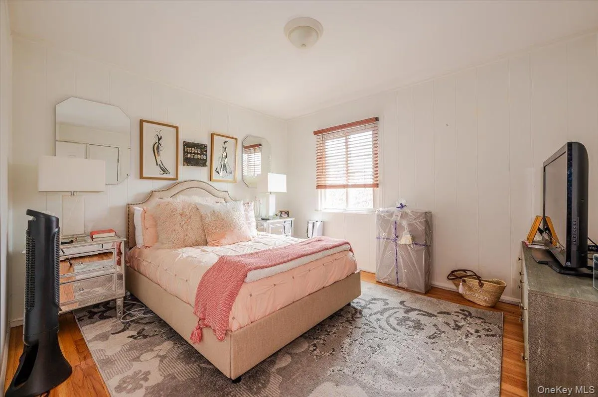 Bedroom with wood finished floors and wood walls Bedroom with wood finished floors and wood walls