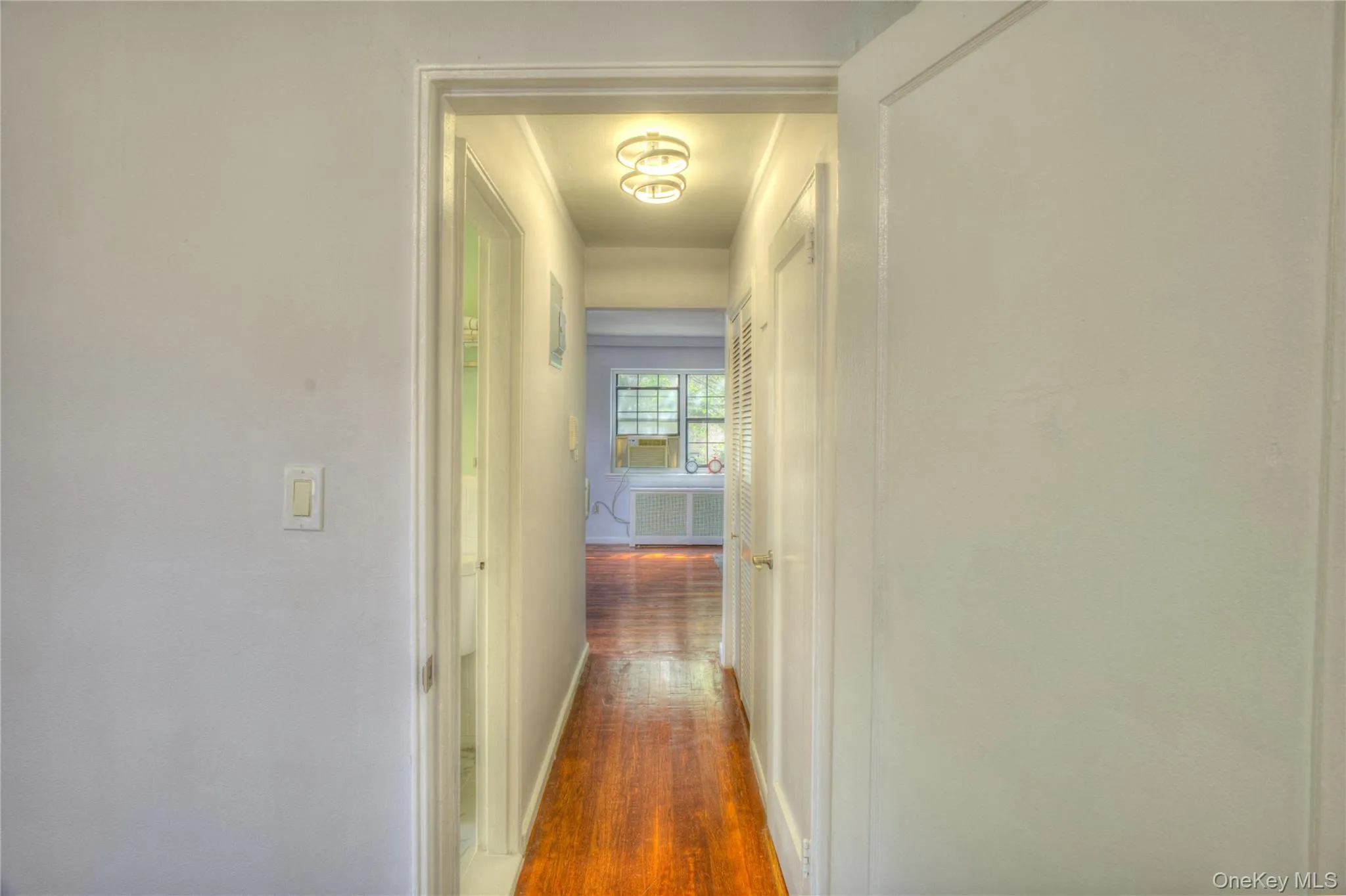Hall featuring dark wood finished floors and baseboards Hall featuring dark wood finished floors and baseboards