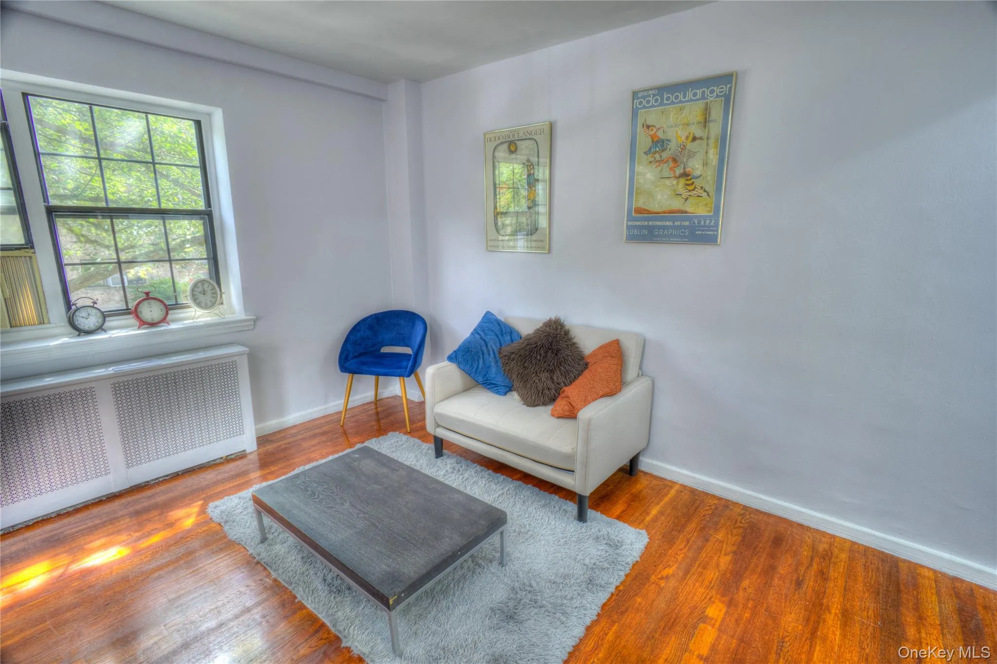 Sitting room featuring radiator and wood finished floors Sitting room featuring radiator and wood finished floors