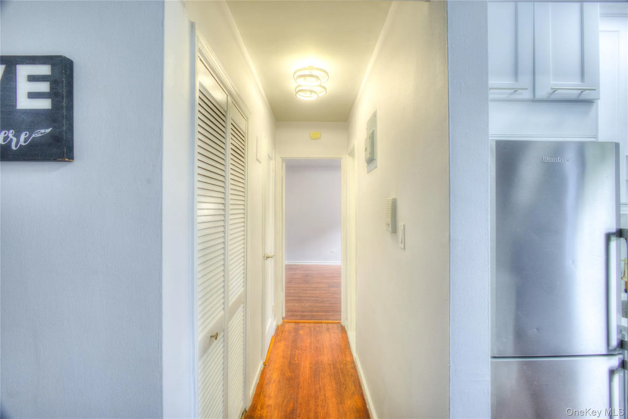 Hall with dark wood finished floors and baseboards Hall with dark wood finished floors and baseboards