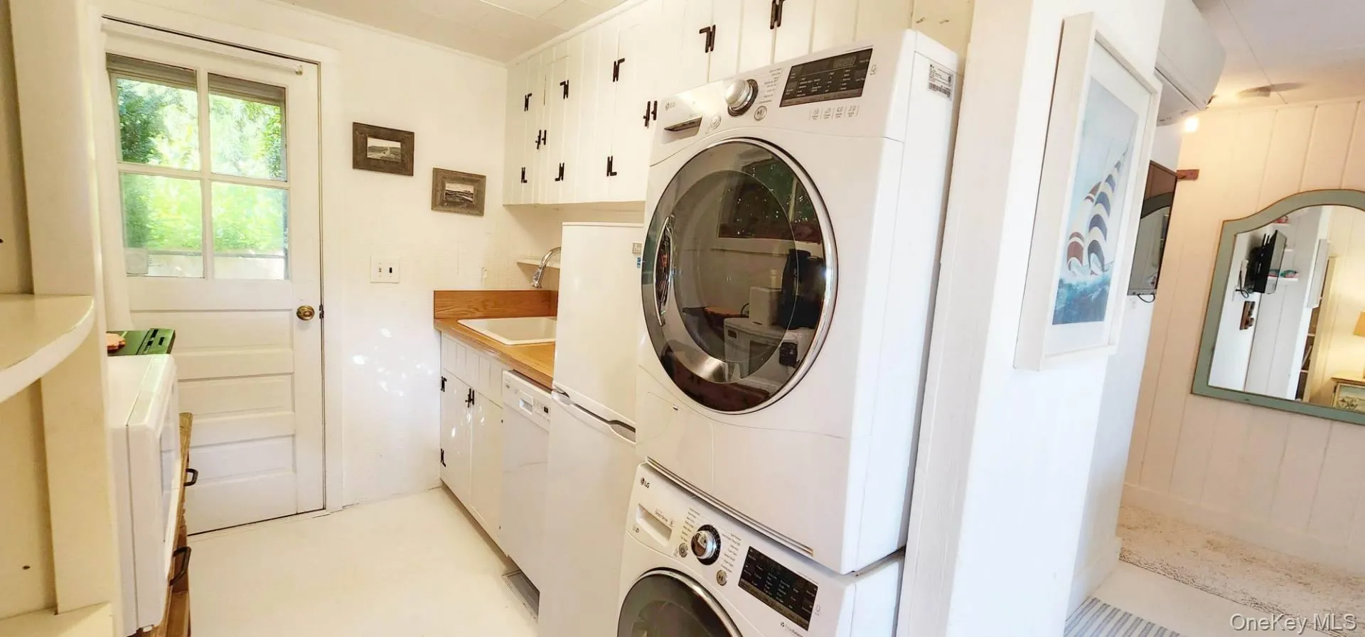 Laundry room with estacked washer and dryer and cabinet space Laundry room with estacked washer and dryer and cabinet space