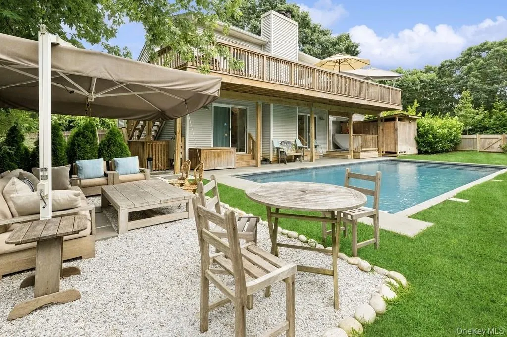 Back of house featuring outdoor lounge area, a patio area, and a chimney Back of house featuring outdoor lounge area, a patio area, and a chimney