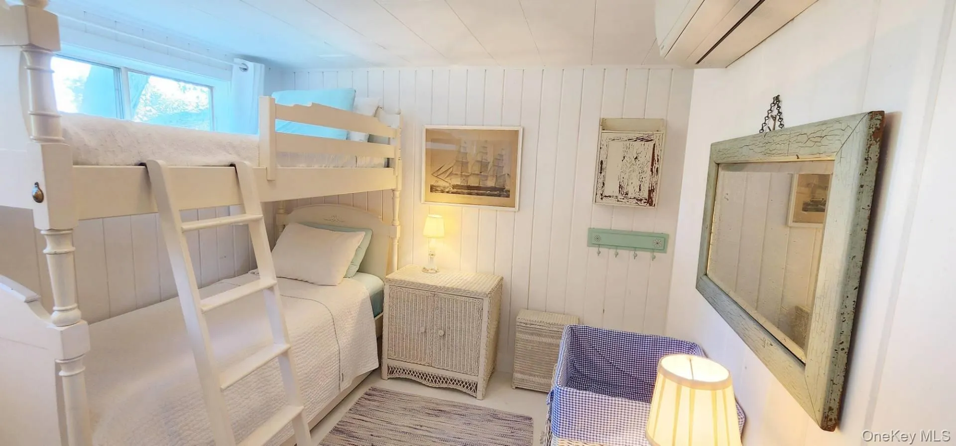 Bedroom with wood walls and an AC wall unit Bedroom with wood walls and an AC wall unit