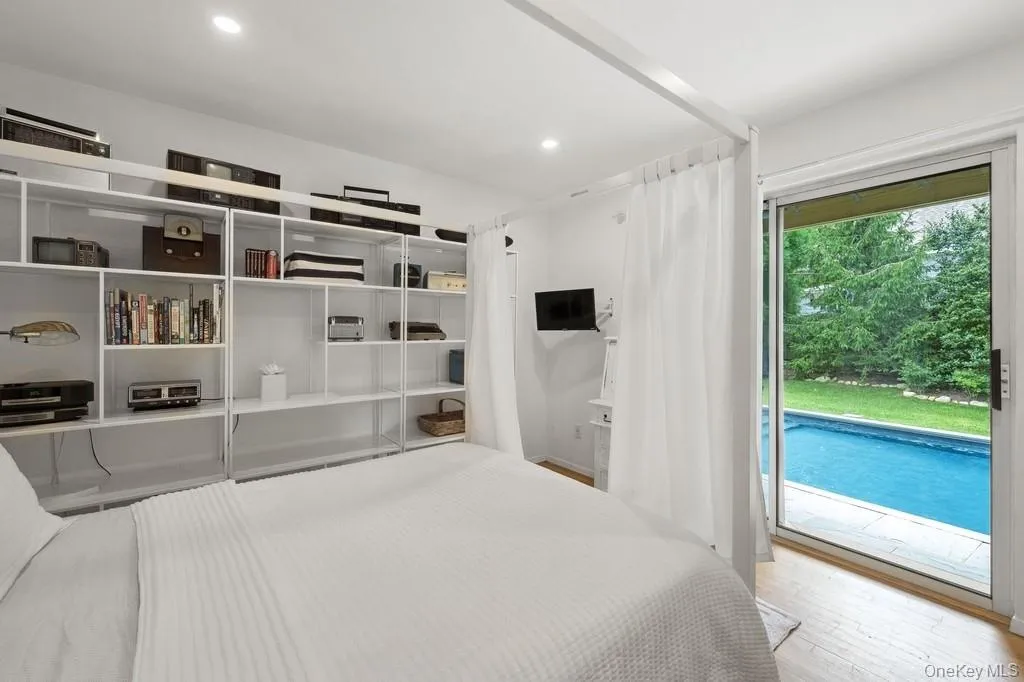 Unfurnished bedroom featuring wood finished floors, access to outside, and recessed lighting Unfurnished bedroom featuring wood finished floors, access to outside, and recessed lighting