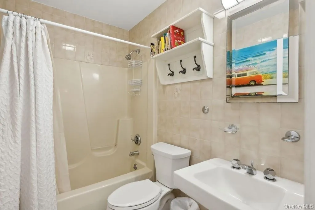 Full bathroom featuring tile walls and shower / bath combo Full bathroom featuring tile walls and shower / bath combo