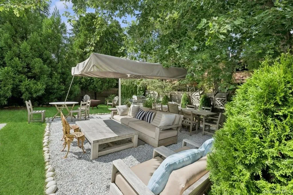 View of patio with an outdoor living space, outdoor dining space, and view of scattered trees View of patio with an outdoor living space, outdoor dining space, and view of scattered trees