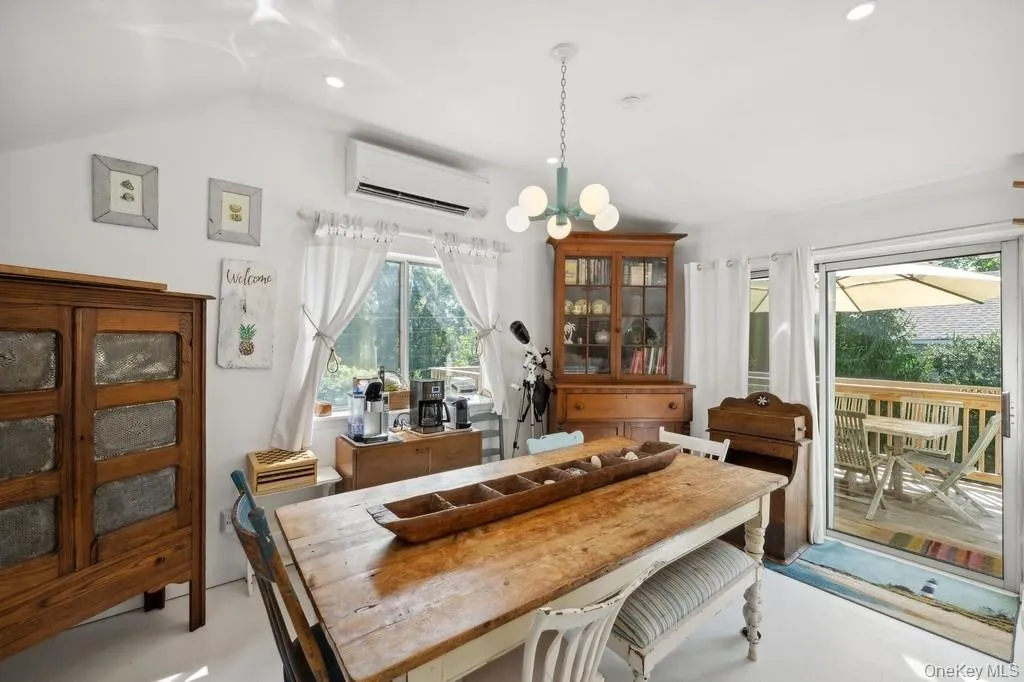Dining area with healthy amount of natural light, a chandelier, a wall mounted air conditioner, and recessed lighting Dining area with healthy amount of natural light, a chandelier, a wall mounted air conditioner, and recessed lighting