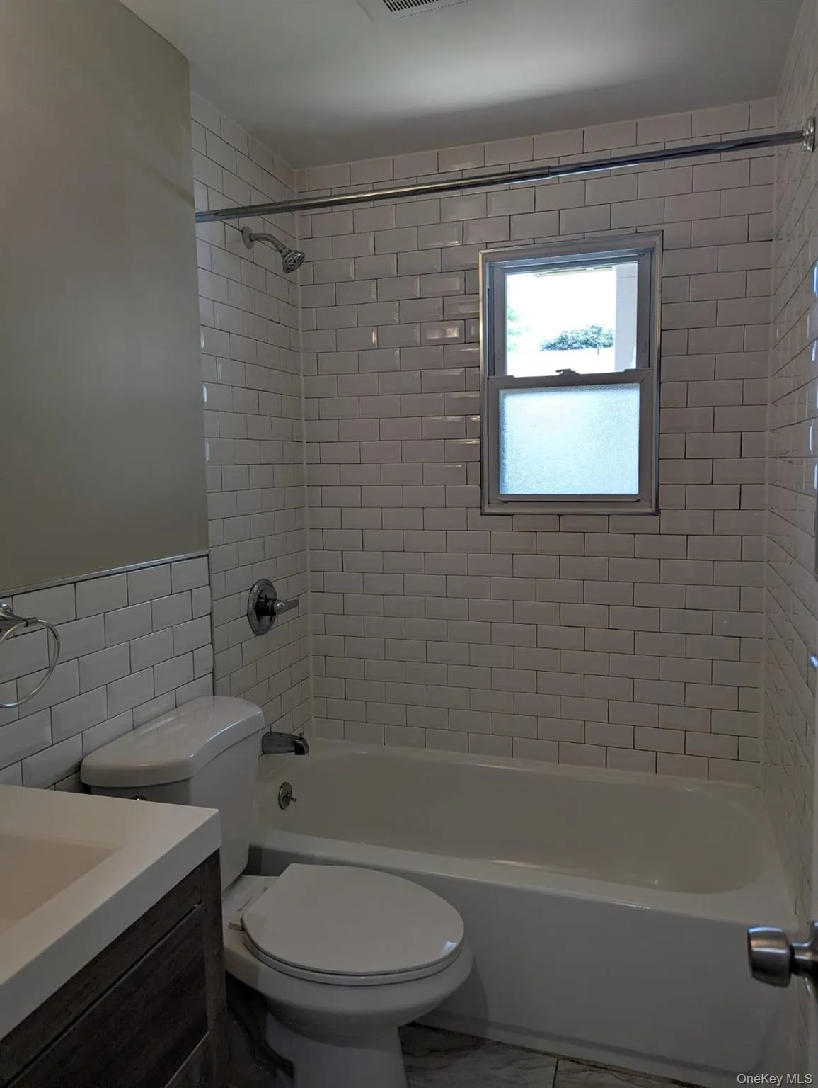 Full bathroom featuring tile walls, shower / washtub combination, and vanity Full bathroom featuring tile walls, shower / washtub combination, and vanity