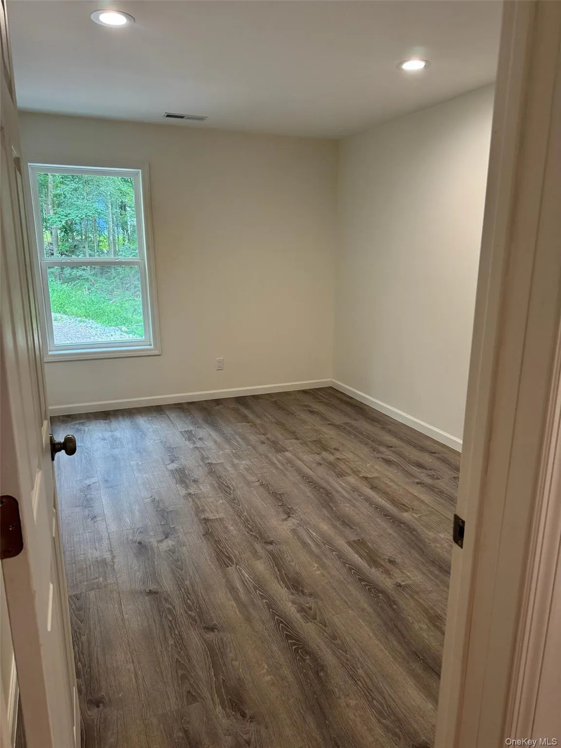 Unfurnished room featuring recessed lighting and wood finished floors Unfurnished room featuring recessed lighting and wood finished floors