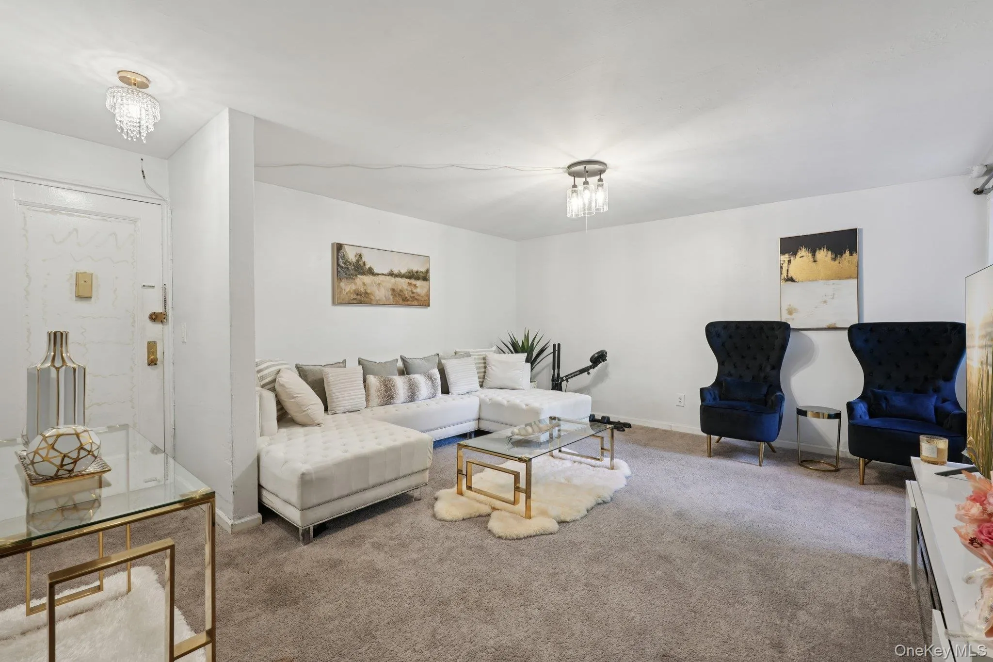 Living room with carpet floors and a chandelier Living room with carpet floors and a chandelier