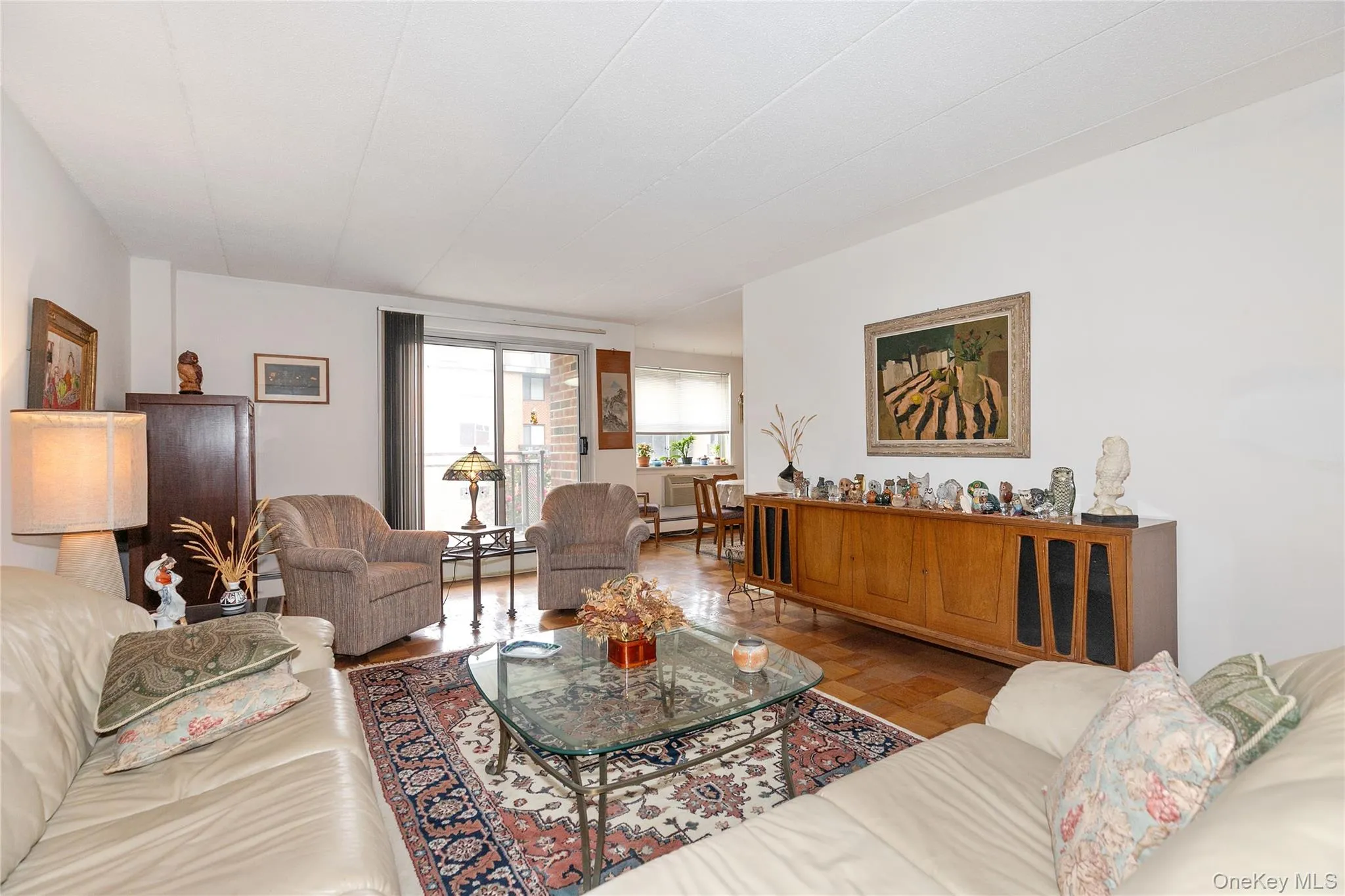 Living room featuring wood finished floors and a baseboard radiator Living room featuring wood finished floors and a baseboard radiator