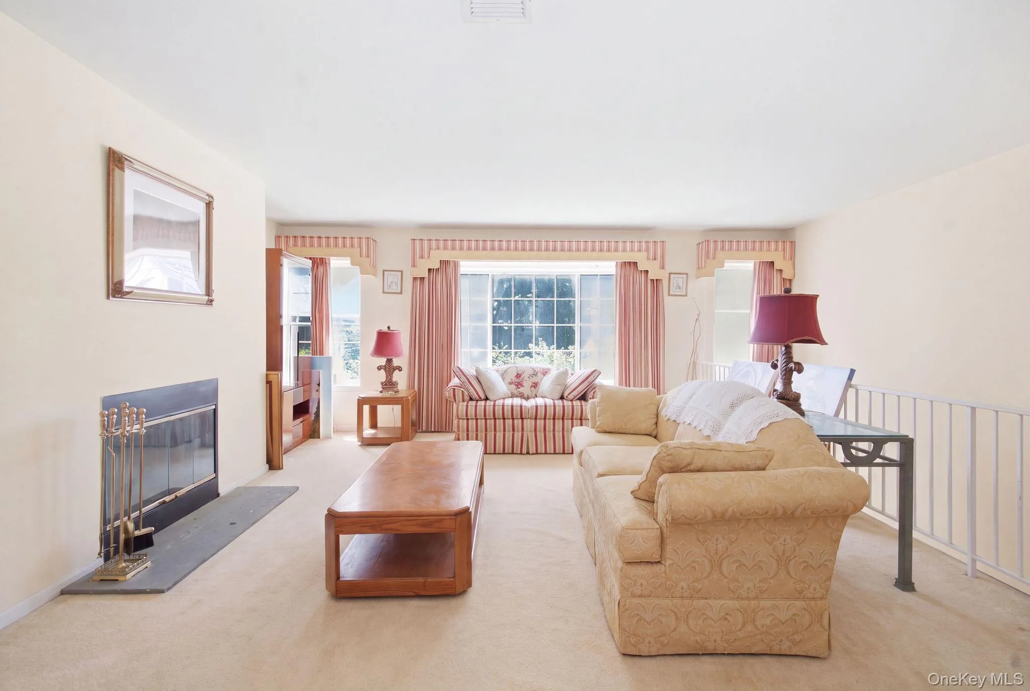 (Digitally decluttered) Envision the living room set above the street, with space to gather, entertain or settle in by the fire. (Digitally decluttered) Envision the living room set above the street, with space to gather, entertain or settle in by the fire.