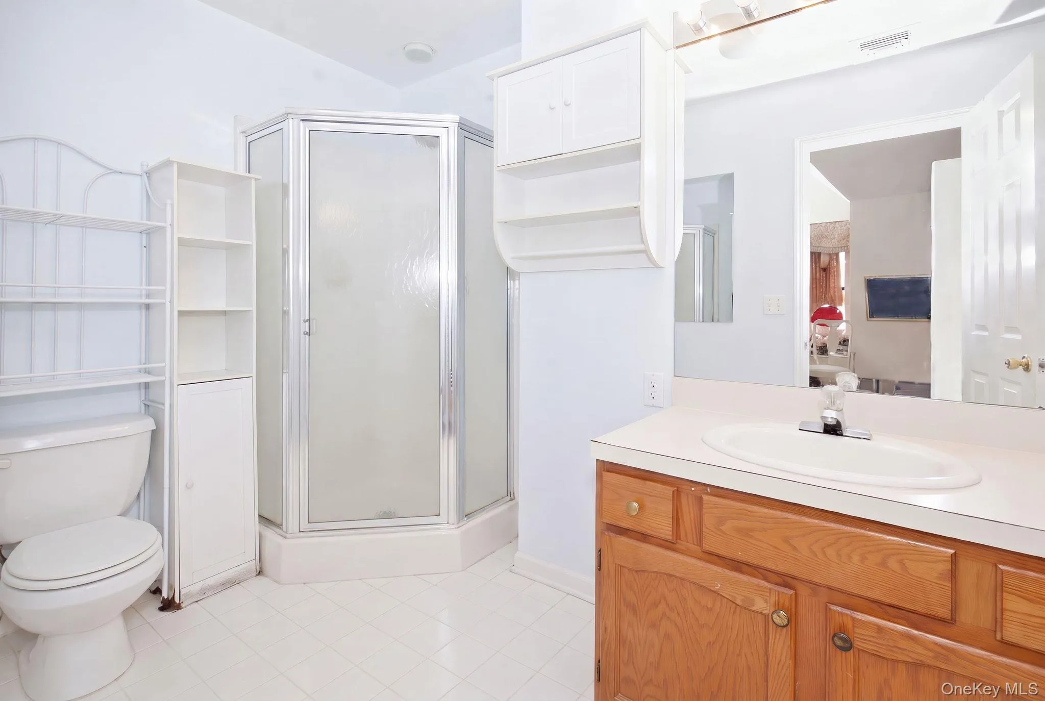 (Digitally decluttered) Picture the primary bath ready for your style, with a corner shower, tile floor and built-in shelving. (Digitally decluttered) Picture the primary bath ready for your style, with a corner shower, tile floor and built-in shelving.