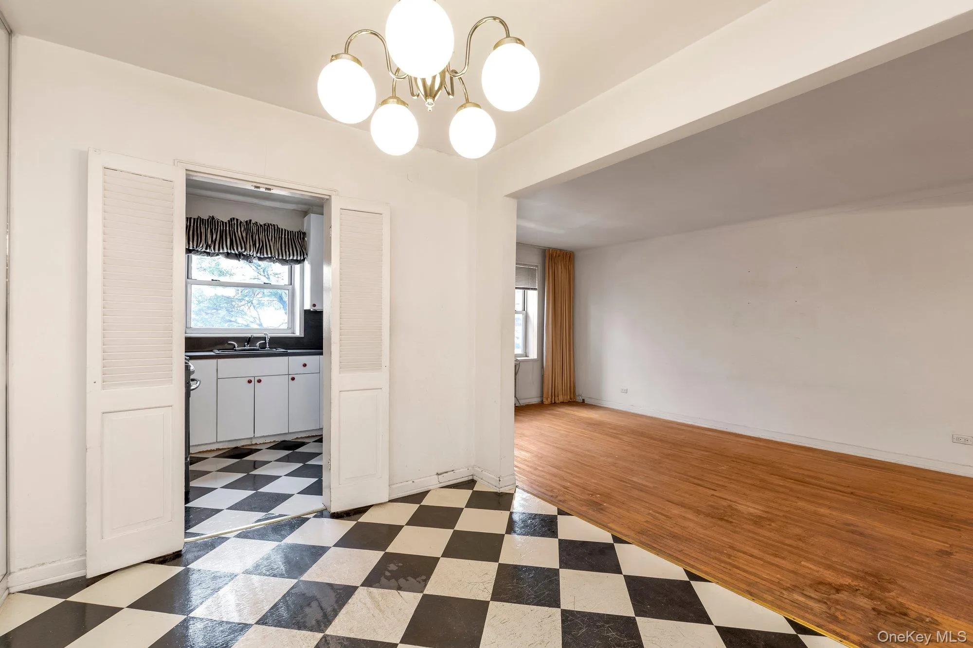 Unfurnished dining area featuring light flooring and a chandelier Unfurnished dining area featuring light flooring and a chandelier