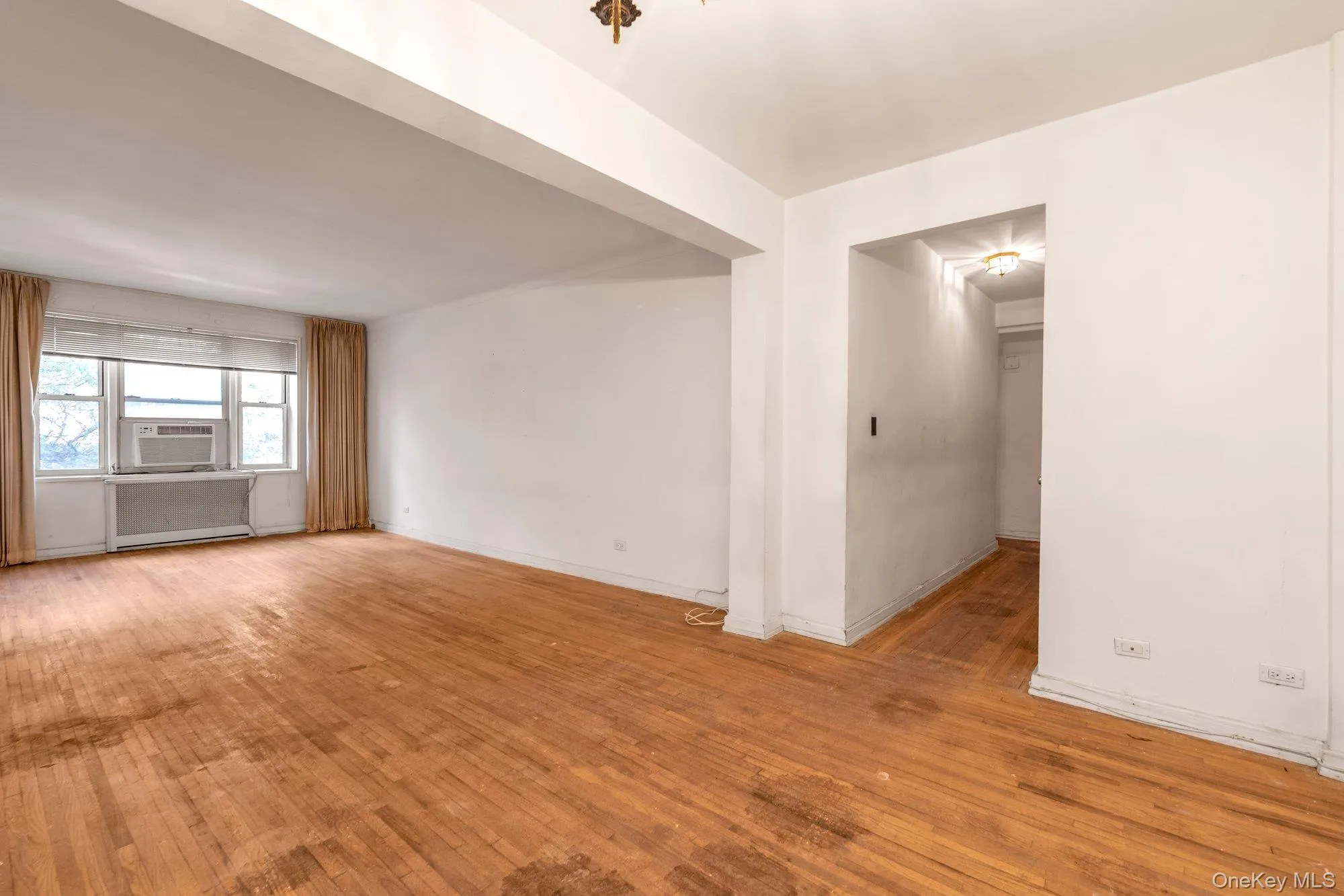 Spare room featuring light wood finished floors and baseboards Spare room featuring light wood finished floors and baseboards