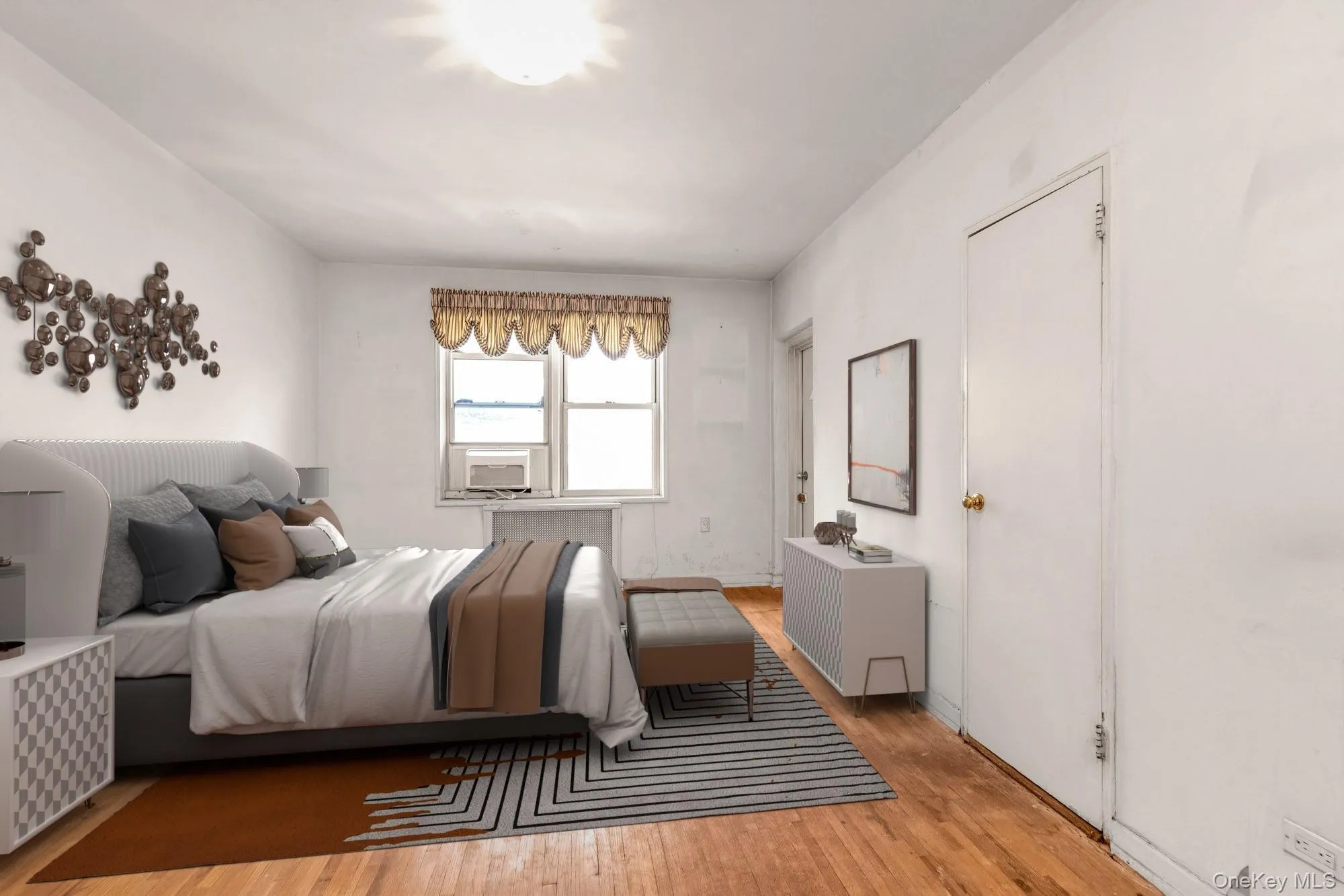 Bedroom featuring wood finished floors and radiator heating unit Bedroom featuring wood finished floors and radiator heating unit