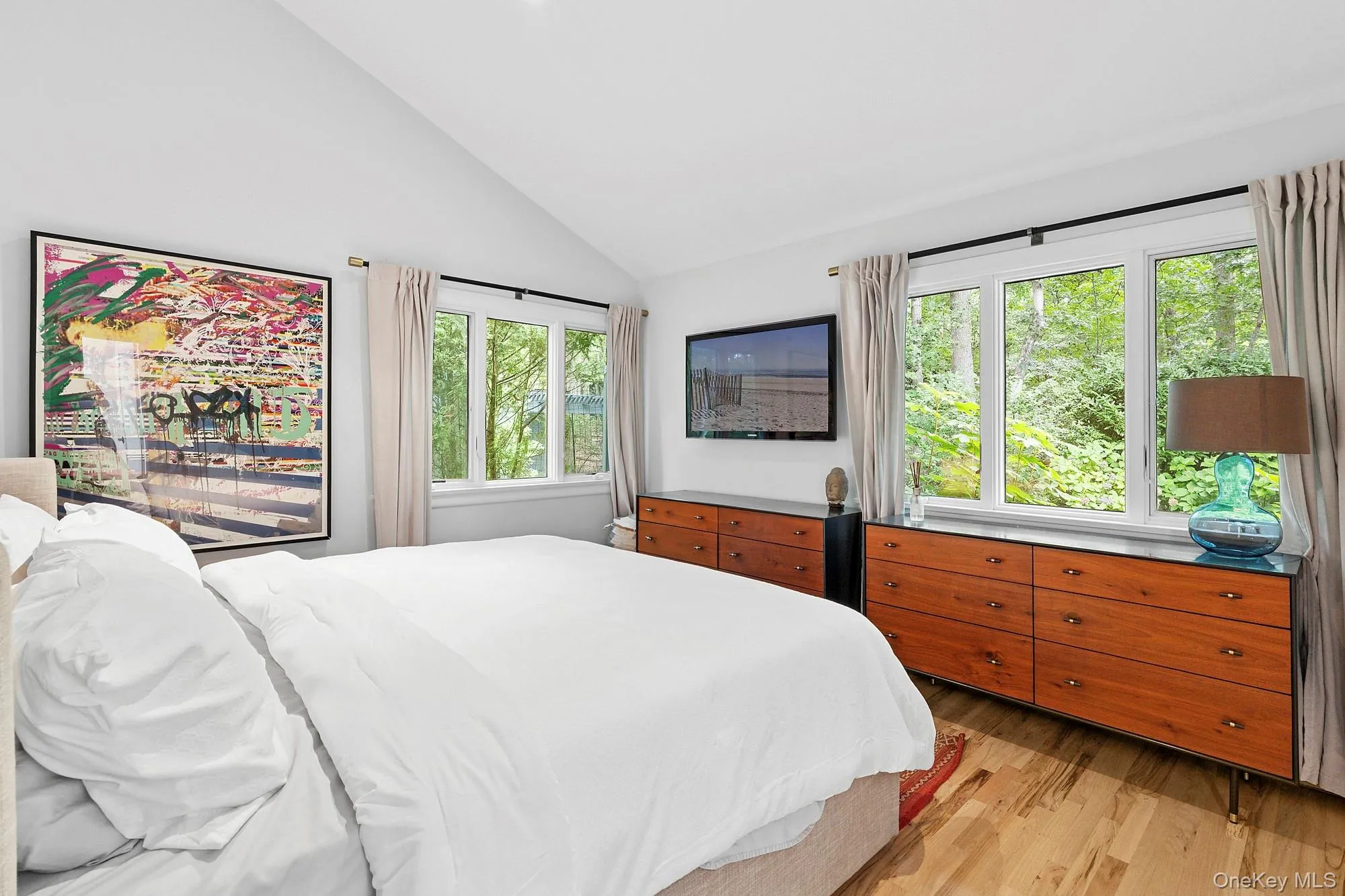 Bedroom with lofted ceiling and light wood-style flooring Bedroom with lofted ceiling and light wood-style flooring