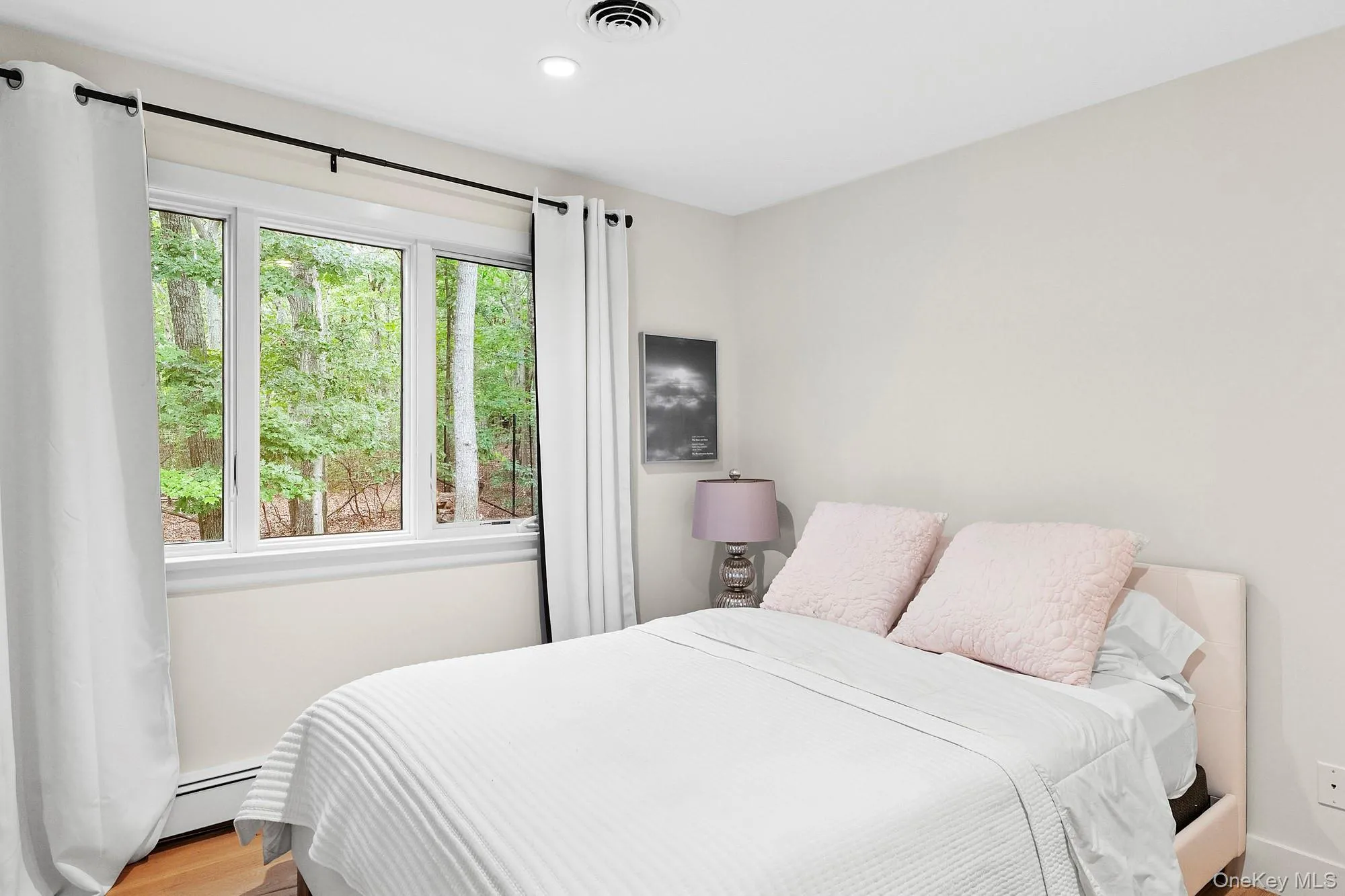 Bedroom with wood finished floors, baseboard heating, and recessed lighting Bedroom with wood finished floors, baseboard heating, and recessed lighting