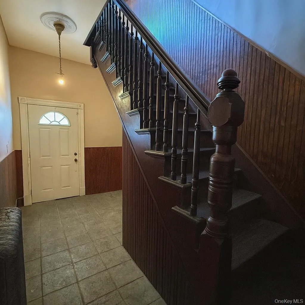 Entrance foyer with stairs leading up to apartment Entrance foyer with stairs leading up to apartment