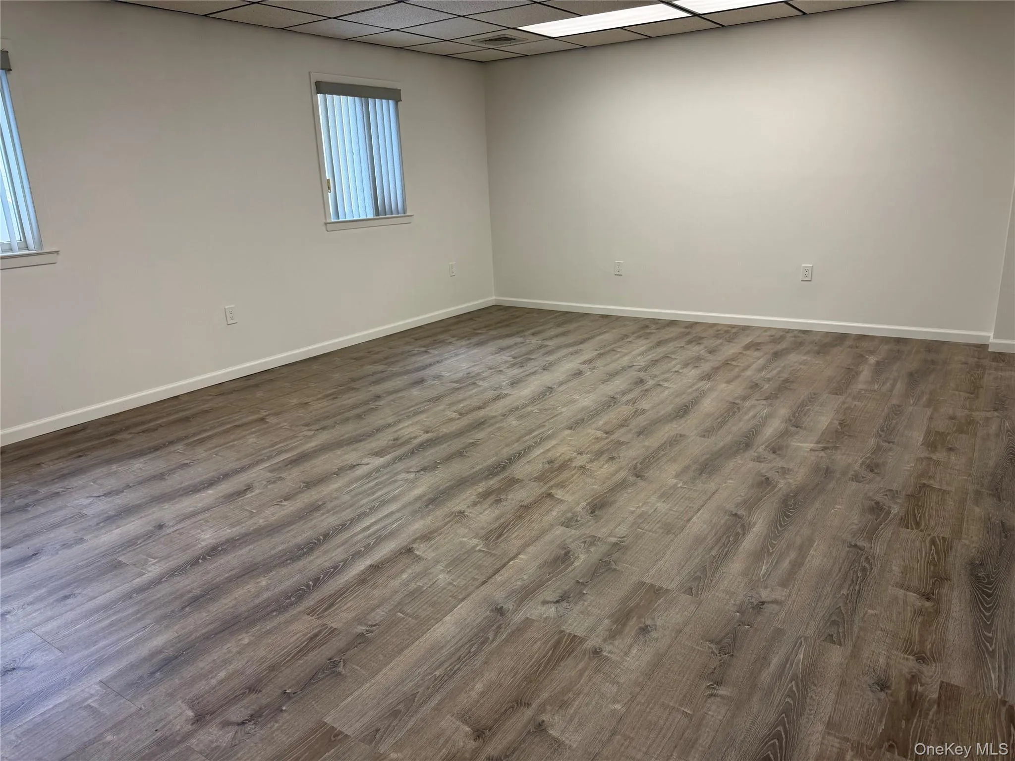 Spare room with a paneled ceiling and wood finished floors Spare room with a paneled ceiling and wood finished floors