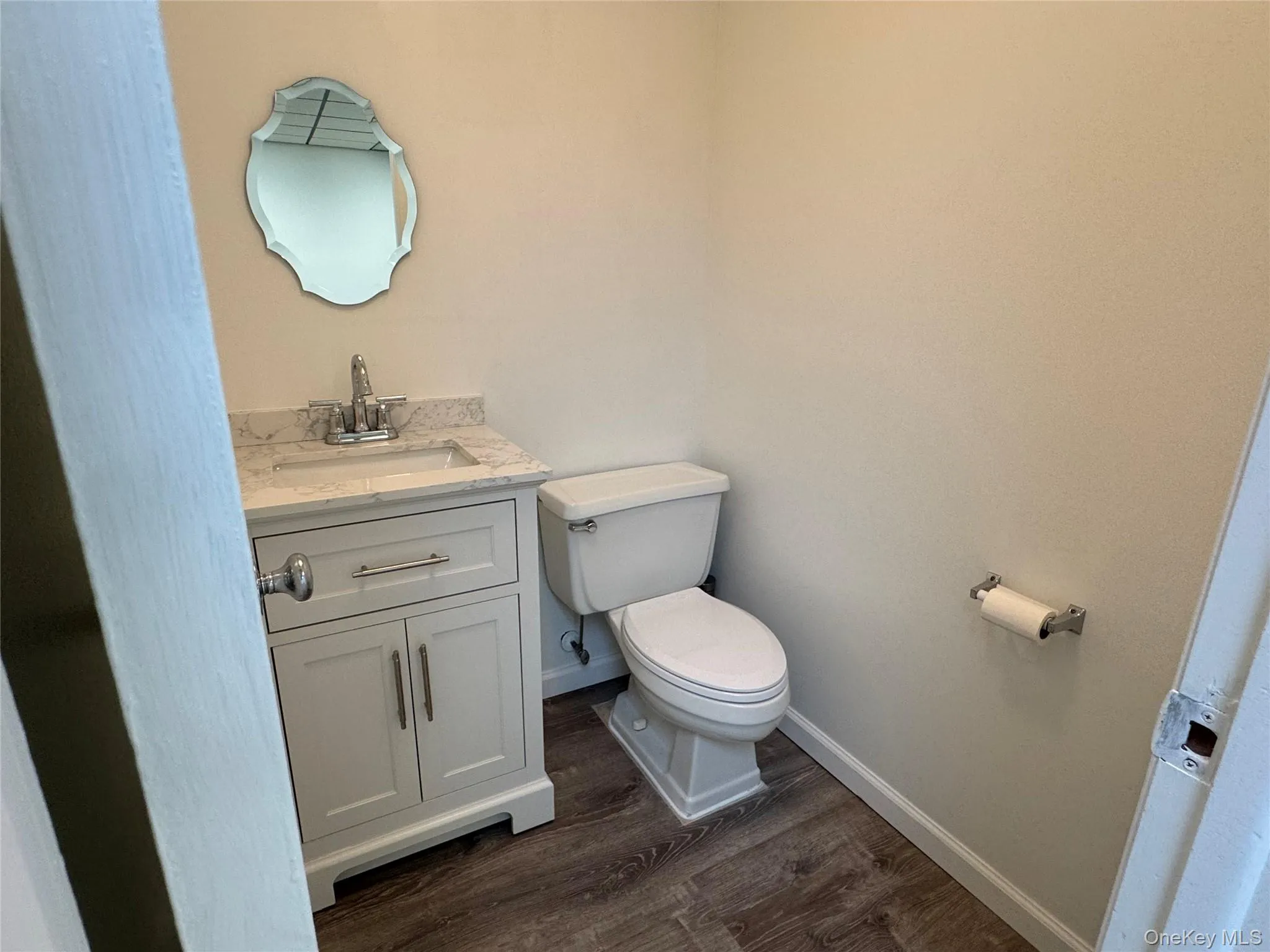 Basement with a drop ceiling and wood finished floors Basement with a drop ceiling and wood finished floors