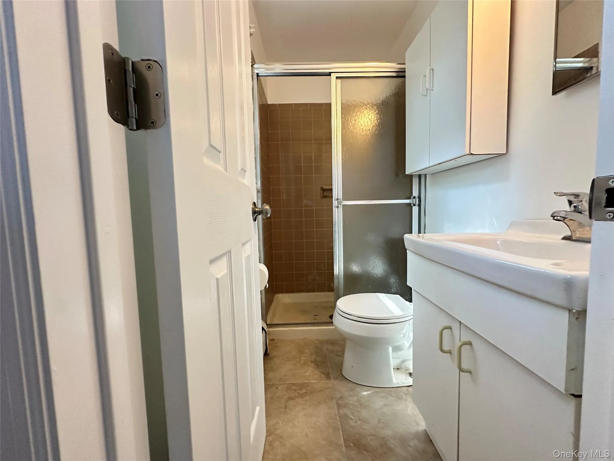 Full bath featuring vanity and a shower stall Full bath featuring vanity and a shower stall