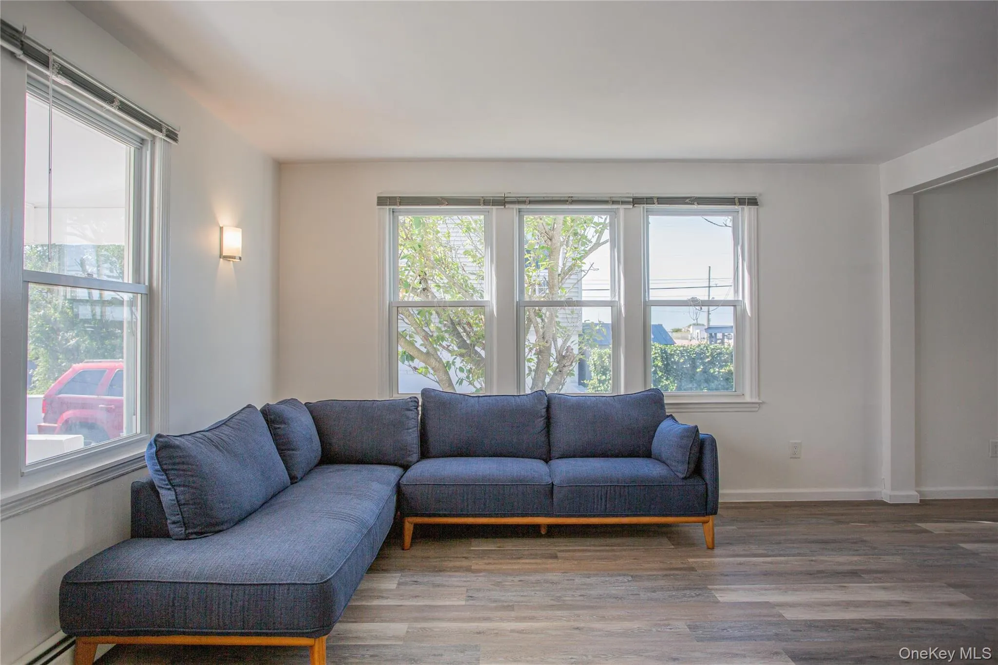 Living area with light wood finished floors and baseboard heating Living area with light wood finished floors and baseboard heating