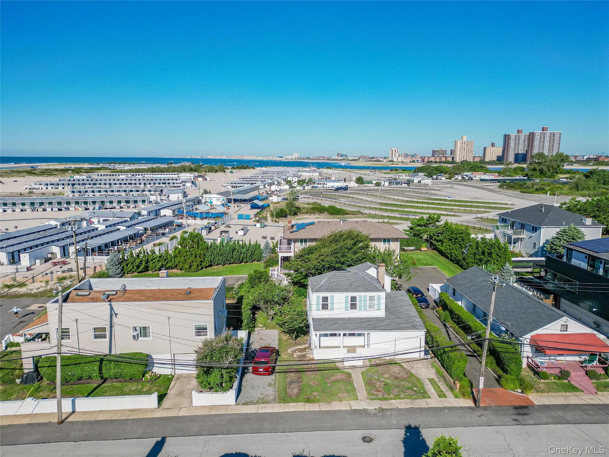 Aerial perspective of suburban area featuring a large body of water Aerial perspective of suburban area featuring a large body of water